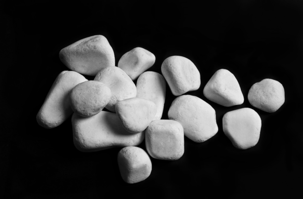 white stones against black background (sauna rocks for sales)