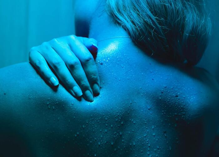 woman sweating in a sauna