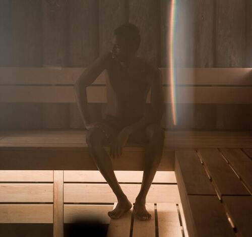 man sitting in a steam room