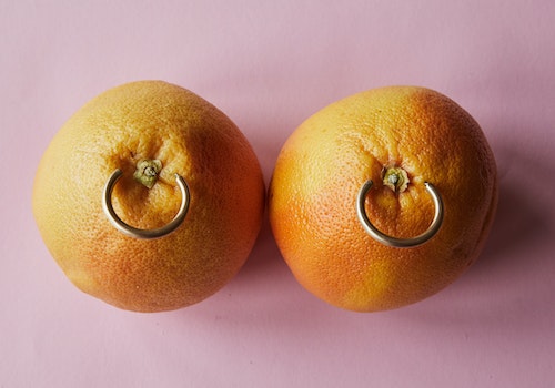 metal rings piercing oranges