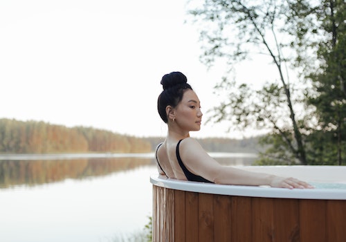 woman sitting on a hot tub in lake side