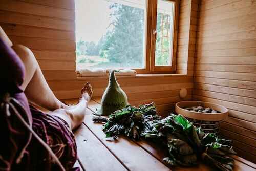 woman sitting inside the sauna looking out the window